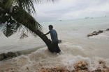 A South Pacific islander watches as a Image of A South Pacific islander watches as a