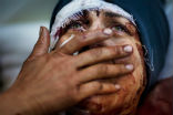 A Syrian woman mourns as her town is razed by Islamist rebels. Image of A Syrian woman mourns as her town is razed by Islamist rebels.