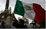 Pemex Gas Station. Nearby protesters are corralled by police in riot gear, underscoring the intensity of the issue for the Mexican people. Image of Pemex Gas Station. Nearby protesters are corralled by police in riot gear, underscoring the intensity of the issue for the Mexican people.