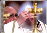 Pope Francis elevating the Consecrated Host at Holy Mass Image of Pope Francis elevating the Consecrated Host at Holy Mass