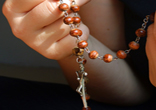 Praying the rosary, keeping the Faith. Image of Praying the rosary, keeping the Faith.
