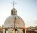 A church tower riddled with bullet holes. Christians are finding it harder to remain neutral as jihadists close in. Image of A church tower riddled with bullet holes. Christians are finding it harder to remain neutral as jihadists close in.