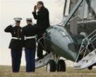 Obama talks on his phone while saluting Marines. Image of Obama talks on his phone while saluting Marines.