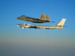 An American F-22 escorts a Tu-95 bomber away from US airspace. Image of An American F-22 escorts a Tu-95 bomber away from US airspace.