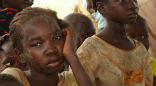 South Sudanese children wait to eat. Food relief is barely trickling in and supplies will run out by the end of May. Image of South Sudanese children wait to eat. Food relief is barely trickling in and supplies will run out by the end of May.