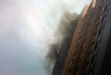 Two firemen fell to their deaths, hand-in-hand while fighting a 13th story apartment fire. Image of Two firemen fell to their deaths, hand-in-hand while fighting a 13th story apartment fire.