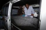 Mohammed Iqbal sits with his wife's body after the police completed their investigation of the scene. Image of Mohammed Iqbal sits with his wife's body after the police completed their investigation of the scene.