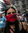 A woman protests the development of the tar sands pipeline through the United States. Image of A woman protests the development of the tar sands pipeline through the United States.