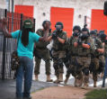 Police in Ferguson move detain a protester. Image of Police in Ferguson move detain a protester.