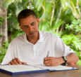 Obama signs a bill while on vacation. Image of Obama signs a bill while on vacation.