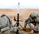 U.S. troops firing a 60mm mortar. Image of U.S. troops firing a 60mm mortar.