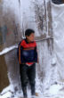 A refugee child shivers in the cold. Even behind the makeshift canvas walls, it isn't much warmer. Image of A refugee child shivers in the cold. Even behind the makeshift canvas walls, it isn't much warmer.