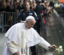Pope Francis lays a flower on the 9/11 memorial before leading a prayer service. Image of Pope Francis lays a flower on the 9/11 memorial before leading a prayer service.