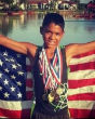 Michael Riley Jr., three-time Junior Olympic qualifier posing with his medals. Image of Michael Riley Jr., three-time Junior Olympic qualifier posing with his medals.