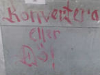 The graffiti scrawled on a restaurant clearly warns Christians to convert or they will be killed. Image of The graffiti scrawled on a restaurant clearly warns Christians to convert or they will be killed.