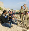 British soldiers question refugees, trying to ensure that none of them are ISIS operatives. Regardless, ISIS now knows of the security flaw. Image of British soldiers question refugees, trying to ensure that none of them are ISIS operatives. Regardless, ISIS now knows of the security flaw.