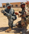 U.S. soldier teaches Syrian rebel which way to hold his weapon (U.S. Army). Image of U.S. soldier teaches Syrian rebel which way to hold his weapon (U.S. Army).