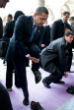 Obama removes his shoes before entering a mosque. Image of Obama removes his shoes before entering a mosque.
