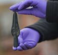 An archaeologist holds a spear point recovered from the site. The artifacts are so well preserved, they're providing a detailed look into Bronze Age life. Image of An archaeologist holds a spear point recovered from the site. The artifacts are so well preserved, they're providing a detailed look into Bronze Age life.