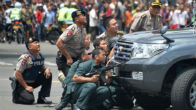 Indonesian police take cover during the ISIS attacks in Jakarta. Image of Indonesian police take cover during the ISIS attacks in Jakarta.