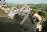 A luxury home collapses in California in March, 1998. Image of A luxury home collapses in California in March, 1998.