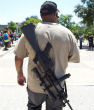 A man open carries a firearm on a college campus. Perhaps seeing firearms more often will convince people that firearms are also safe? Image of A man open carries a firearm on a college campus. Perhaps seeing firearms more often will convince people that firearms are also safe?
