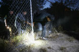 In many places, the border is only defended by a small fence or a few strands of barbed wire. Image of In many places, the border is only defended by a small fence or a few strands of barbed wire.