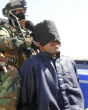 An Iraqi militia takes an ISIS captive into custody. Not all of the captives will have the luxury of a fair trial. Image of An Iraqi militia takes an ISIS captive into custody. Not all of the captives will have the luxury of a fair trial.