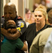 A police officer embraces a friend in the aftermath of the shootings. Image of A police officer embraces a friend in the aftermath of the shootings.