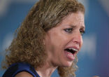Debbie Wasserman Schultz attempts to stand against her critics (YouTube). Image of Debbie Wasserman Schultz attempts to stand against her critics (YouTube).