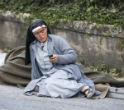 A nun rests after escaping the quake. Image of A nun rests after escaping the quake.