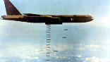 A B-52 bomber drops bombs during the Vietnam War. Image of A B-52 bomber drops bombs during the Vietnam War.