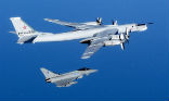 A NATO fighter escorts a Russian long-range bomber. Several such flights have occurred recently as the Russians assert themselves as a superpower once more. Image of A NATO fighter escorts a Russian long-range bomber. Several such flights have occurred recently as the Russians assert themselves as a superpower once more.
