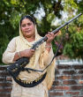 Shahana Begum protects women with her shotgun and as a result, violence against women has dropped dramatically. Image of Shahana Begum protects women with her shotgun and as a result, violence against women has dropped dramatically.