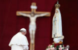 Pope Francis kneeling before a statue of Our Lady of Fatima. Image of Pope Francis kneeling before a statue of Our Lady of Fatima.