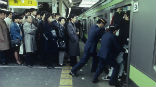 Tokyo is so crowded that special workers cram people into the subway trains there. Image of Tokyo is so crowded that special workers cram people into the subway trains there.