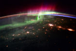 The aurora are caused by charged particles that are drawn into the atmosphere by Earth's magnetic field where they strike gas molecules, causing them to glow. Image of The aurora are caused by charged particles that are drawn into the atmosphere by Earth's magnetic field where they strike gas molecules, causing them to glow.