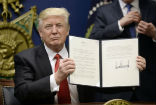 Trump holds his executive order banning immigration for refugees and from seven countries until Homeland Security can revamp vetting procedures. Image of Trump holds his executive order banning immigration for refugees and from seven countries until Homeland Security can revamp vetting procedures.