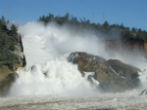 Water rushes down the spillway and into the eroded area outside the dam. Erosion is threatening the integrity of the system and up to a quarter million people could be affected. Image of Water rushes down the spillway and into the eroded area outside the dam. Erosion is threatening the integrity of the system and up to a quarter million people could be affected.