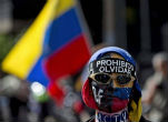 A protestor wears a bandana that reads, 'prohibited to forget.' Image of A protestor wears a bandana that reads, 'prohibited to forget.'