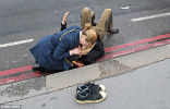 A women comforts a victim who survived the attack with injuries. Several people have serious injuries. Image of A women comforts a victim who survived the attack with injuries. Several people have serious injuries.