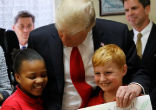 President Trump posed for a picture with two students from St. Andrew Catholic School, telling them Image of President Trump posed for a picture with two students from St. Andrew Catholic School, telling them
