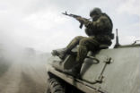 A Russian soldier rides on an armored vehicle in this file image. Image of A Russian soldier rides on an armored vehicle in this file image.