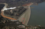 The green area on the face of the dam suggests water is seeping though the dam. Image of The green area on the face of the dam suggests water is seeping though the dam.