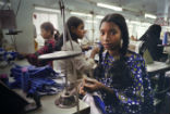 A girl works in a sweatshop, sewing garments. Large numbers of people are enslaved or at least unethically employed. Many products produced by such labor are cheap in price for the consumer, but expensive for the worker. Image of A girl works in a sweatshop, sewing garments. Large numbers of people are enslaved or at least unethically employed. Many products produced by such labor are cheap in price for the consumer, but expensive for the worker.