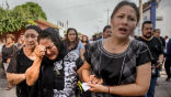 Women mourn as workers search for survivors of the 8.1 quake that struck Mexico in early September. Image of Women mourn as workers search for survivors of the 8.1 quake that struck Mexico in early September.