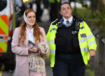 An injured woman is escorted away from the site of the attack where 22 people were injured. Image of An injured woman is escorted away from the site of the attack where 22 people were injured.
