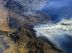 A photo from the International Space Station shows smoke from the fires blowing out to sea. Image of A photo from the International Space Station shows smoke from the fires blowing out to sea.