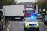 Police officers drive away a lorry in which was discovered 39 dead bodies at Waterglade Industrial Park in Grays east of London Oct 23 2019 Image of Police officers drive away a lorry in which was discovered 39 dead bodies at Waterglade Industrial Park in Grays east of London Oct 23 2019