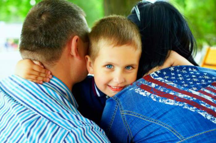 Smiling kid with parents Smiling kid with parents